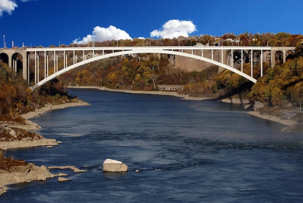 A white bridge over a river.